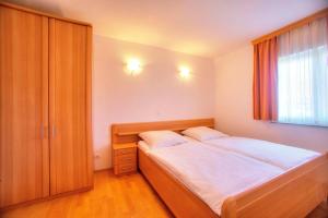 a small bedroom with a bed and a window at Villa D&I in Vodice