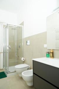 a bathroom with a shower and a toilet and a sink at Scirocco Guest House in Brindisi