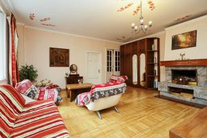 a living room with two couches and a fireplace at Sunny Grand Apartment by Old Town in Rīga