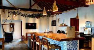 un bar en una habitación con mesa y sillas en Villa Pousada 35knots Brasil, en Ponta do Anel