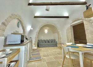 a living room with a couch and a table at Antico Trullo Pasubio in Alberobello