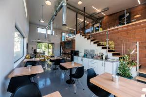 a restaurant with tables and chairs and a staircase at Albergue Santiago 15 Monforte in Monforte de Lemos