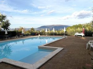a swimming pool with a view of the mountains at La Macina di Bettona in Bettona +34 photos