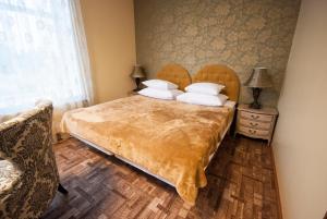 a bedroom with a large bed with white pillows at Villa & Restoran Soffa in Haapsalu