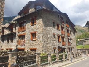an old stone building with windows and a balcony at Francoli in Canillo