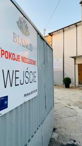 a sign that reads blanco pueblo violence violence usgue at Bianco - pokoje noclegowe in Częstochowa +8 photos