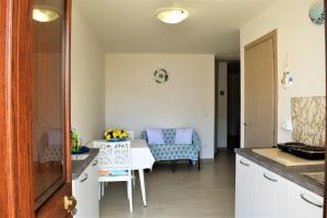 a kitchen and dining room with a table and chairs at Casa vacanze Pesce azzurro in Castro di Lecce