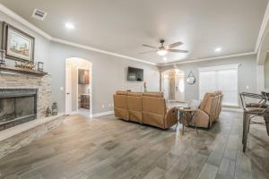 a living room with a couch and a fireplace at Cheerful 3 Bedroom Home, King Bed, 10 min from Palo Duro Canyon, Fireplace, Washer Dryer in Canyon
