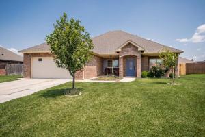 a house with a tree in the yard at Cheerful 3 Bedroom Home, King Bed, 10 min from Palo Duro Canyon, Fireplace, Washer Dryer in Canyon