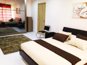 a bedroom with a large bed and a living room at Antik Malta in Sliema