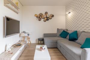 un salon avec un canapé et une télévision à écran plat dans l'établissement LYS - 7 Min des parcs Walt Disney- Parfait pour les familles- Arrivée Autonome - Parking & Wifi Gratuit, à Magny-le-Hongre