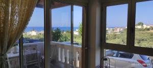 カト・ダラトソにあるJoaMe Villaの海の景色を望む窓3つが備わる客室です。