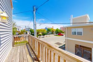 a balcony with a wooden railing next to a house at 900 Philadelphia in Ocean City