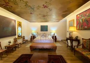 a bedroom with a bed and a painting on the ceiling at Casa San Marcos by Prima Collection in Quito