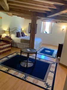 a bedroom with a bed and a stool in a room at Fiddleback Farm in Wigton