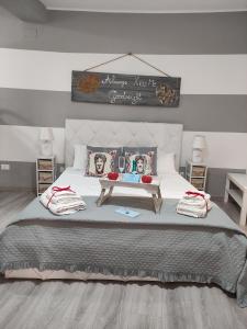 a bedroom with a large bed with a sign above it at Sicilia Bedda house in Cefalù