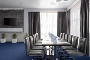 a conference room with a long table and chairs at Parallel Hotel & Conference Krasnodar in Krasnodar