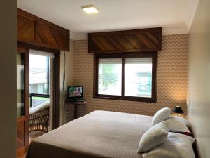 Ένα ή περισσότερα κρεβάτια σε δωμάτιο στο Apto 4D Frente Beira Mar