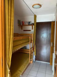 een kamer met 2 stapelbedden in een kamer bij Studio Embrun plan d eau de 2 à 4 personnes situé 3 chemin de chadenas in Embrun