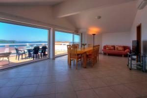 a living room with a table and chairs and a couch at Villa D&I in Vodice