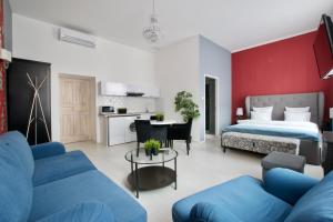 a bedroom with a bed and a blue couch at Premium Apartments by Hi5 - Astoria square in Budapest