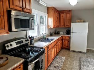 a kitchen with a stove and a refrigerator at Beautiful, Modern & Convenient Home in Quinton, VA in Quinton