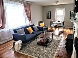 a living room with a blue couch and a table at Beautiful, Modern & Convenient Home in Quinton, VA in Quinton