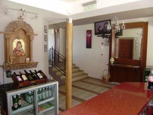 a living room with a staircase and a room with wine bottles at Sea View Family Hotel in Kranevo