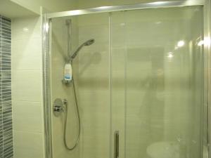 a shower with a glass door in a bathroom at AbitaRoom in Bologna