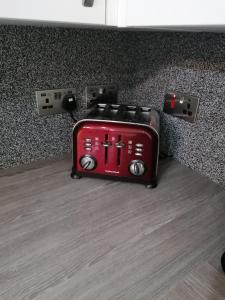 a red toaster sitting on top of a counter at Lovely 2-Bed Apartment in Coventry in Coventry