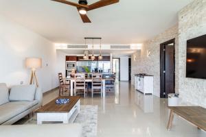 a living room with a couch and a table at Mareazul Beach Front Condos At playa del Carmen in Playa del Carmen