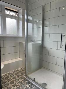 a shower with a glass door in a bathroom at Henbury House in Bristol