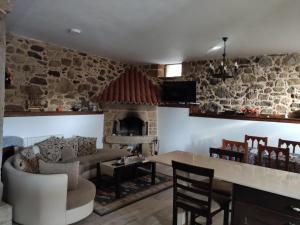 a living room with a couch and a fireplace at Casa Rústica Pedroso in Padrón