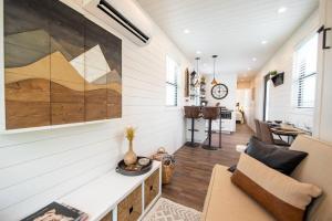 a living room with a couch and a table at The Newtonian Tiny Container Home near Magnolia in Bellmead