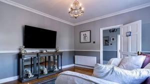 a living room with a tv and a couch at Woodleigh Lodge in Gorey