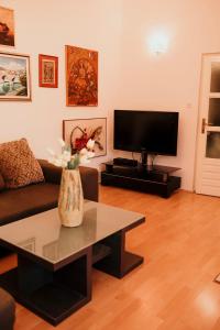 a living room with a couch and a tv at Apartman Balkon in Mostar