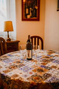 a bottle of wine sitting on a table with glasses at Apartman Balkon in Mostar