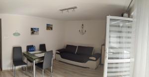 a living room with a couch and a table at APARTAMENT BERMUDY in Świnoujście