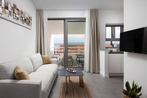 a living room with a couch and a table at Holiday in Bol **** yellow in Bol +6 photos