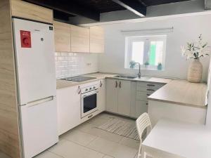 a kitchen with white appliances and a white refrigerator at The Perfect Stay Maspalomas in Maspalomas