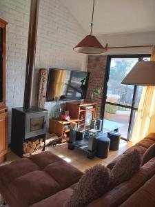 a living room with a couch and a fireplace at Apart en playa hermosa piriapolis a dos cuadras de la playa in Piriápolis
