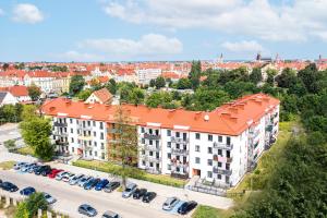 an overhead view of a building with an orange roof at Apartament Uroczy in Legnica
