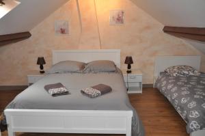 a bedroom with two beds with pillows on it at Chambres d'Hôtes L'Alezan in Orry-la-Ville