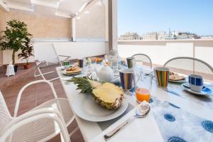 a table with a plate of food on it at Finestre d'Occidente in Trapani