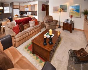 a living room with couches and a coffee table at Vantage Point 101 Condo in Vail