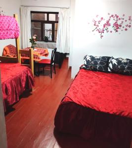 Rúm í herbergi á Cuzco Central Hostel