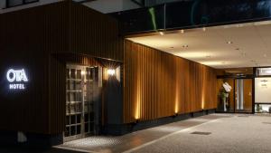 a lobby of a building with aania sign on the wall at Hotel Ohta in Ōzu