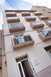 a building with windows on the side of it at Finestre d'Occidente in Trapani