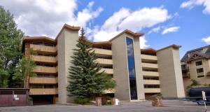 a building with a christmas tree in front of it at Scorpio #104 Condo in Vail