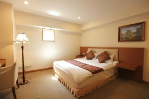Rúm í herbergi á Fujisan Garden Hotel